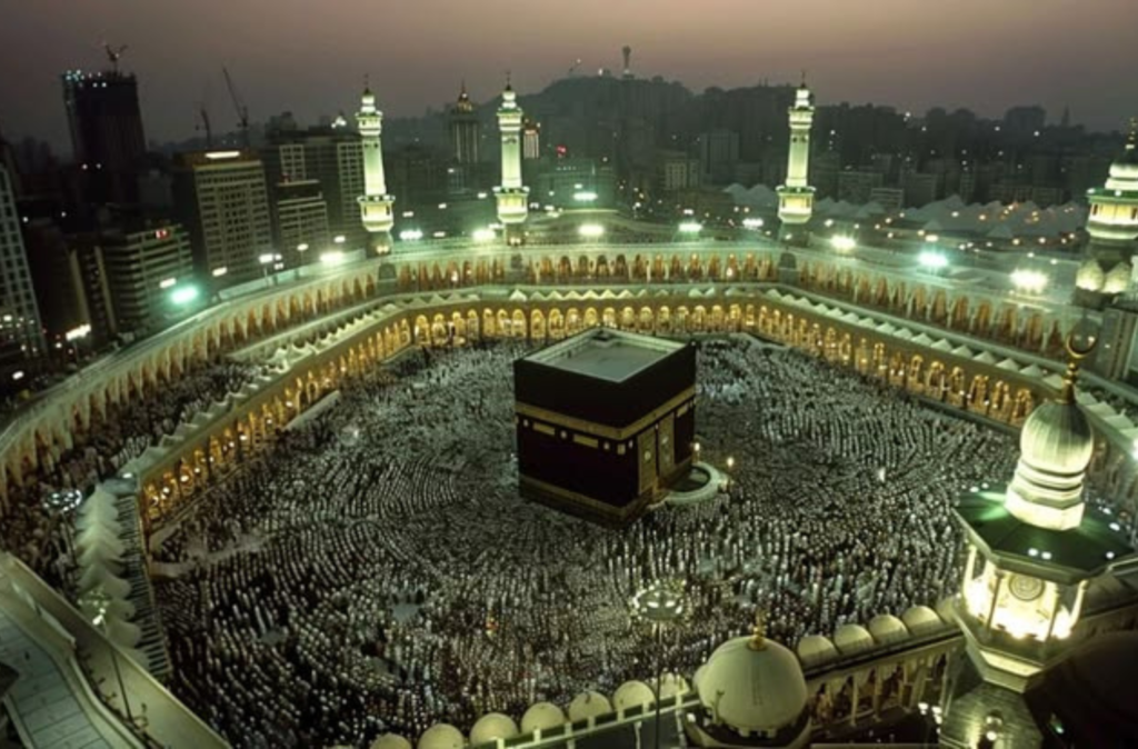 Aerial view of the Kaaba at Masjid-al-Haram in Makkah surrounded by thousands of Muslim pilgrims performing Tawaf during Umrah and Hajj.
