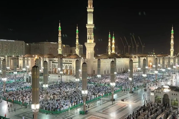 Night view of the courtyard of Masjid-e-Nabawi illuminated in Madinah, Saudi Arabia.