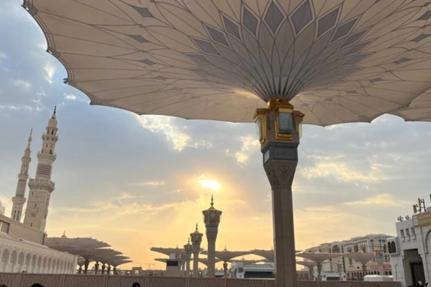 eautiful sunset view beneath the giant umbrellas of Al Masjid-an-Nabawi in Madinah