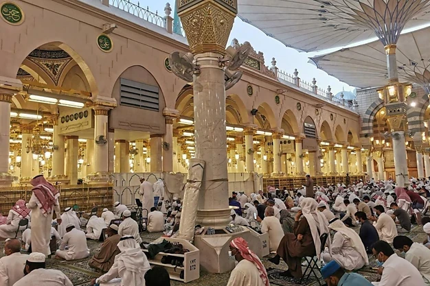 Worshippers gathered for prayer inside Al Masjid e Nabawi courtyard beneath the iconic giant umbrellas