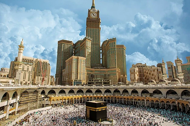 Kaaba at Masjid al-Haram in Makkah with the Abraj Al Bait Clock Tower overlooking Muslim pilgrims during their Umrah pilgrimage.