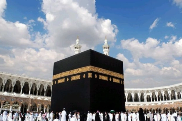 Low-angle view of the Kaaba with pilgrims performing Tawaf at the Grand Mosque in Makkah.