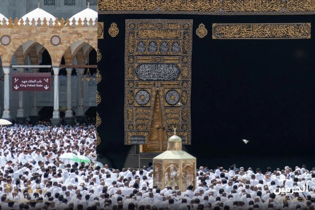Close-up view of the Kaaba door, Maqam Ibrahim and pilgrims at Masjid-al-Haram in Makkah.