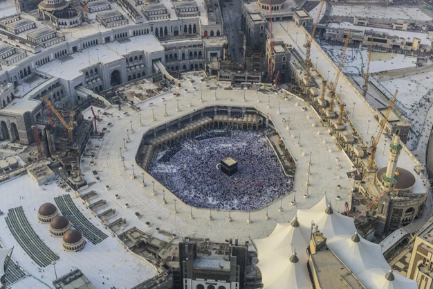 Aerial view of Masjid-al-Haram in Makkah with the Kaaba surrounded by Muslim pilgrims during Umrah and the Grand Mosque expansion.