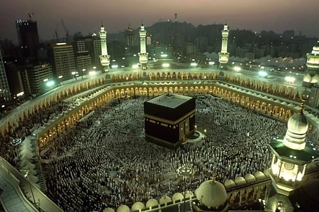 Nighttime view of the Holy Kaaba at Masjid al Haram surrounded bypilgrims gathered for prayer and worship in Saudi Arabia.