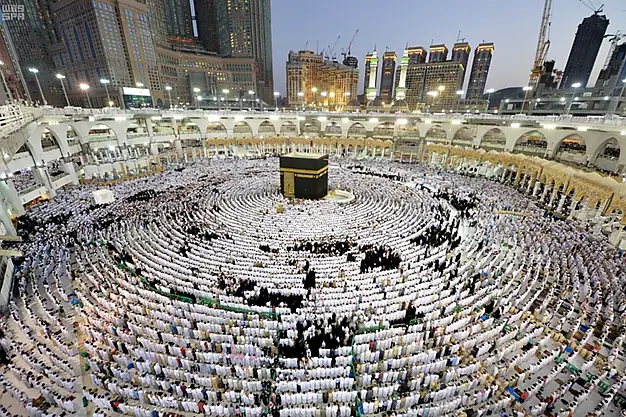 Thousands of Muslim pilgrims praying around the Kaaba at Masjid al Haram in Makkah, Saudi Arabia during Hajj and Umrah pilgrimage.
