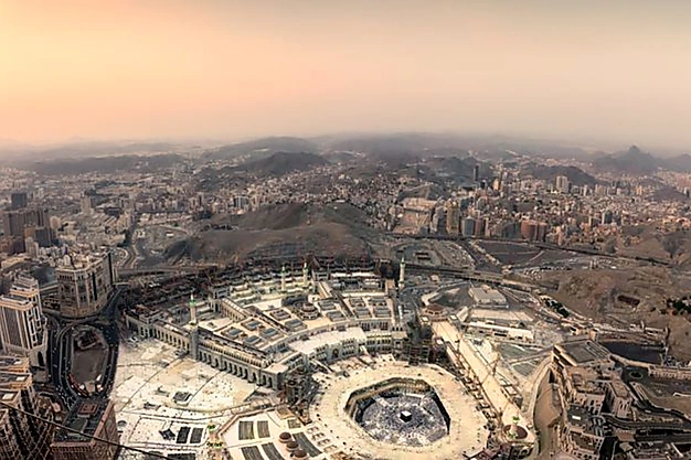 Aerial view of Masjid al Haram in Makkah, Saudi Arabia with the Holy Kaaba surrounded by thousands of Muslim pilgrims performing Tawaf during Hajj and Umrah.