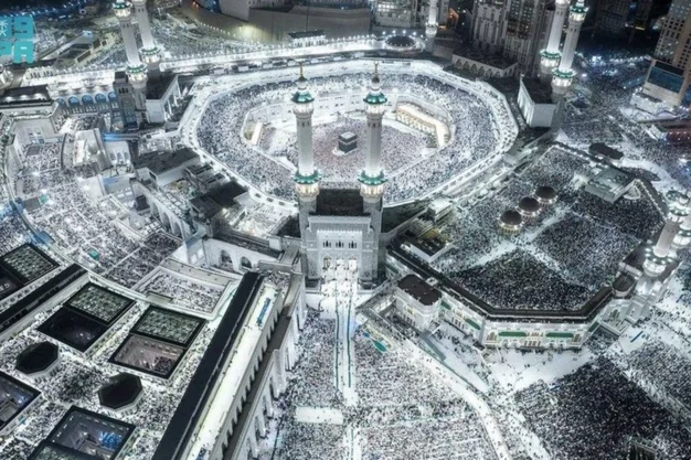 Aerial night view of the Holy Kaaba with thousands of Muslim pilgrims performing Tawaf during Umrah